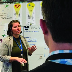 Benefit Services Manager Sarah Dedman walks guests through a DVM board.